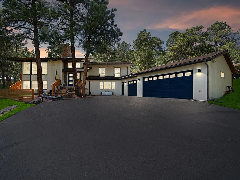 View of home at night. driveway has timed lights.