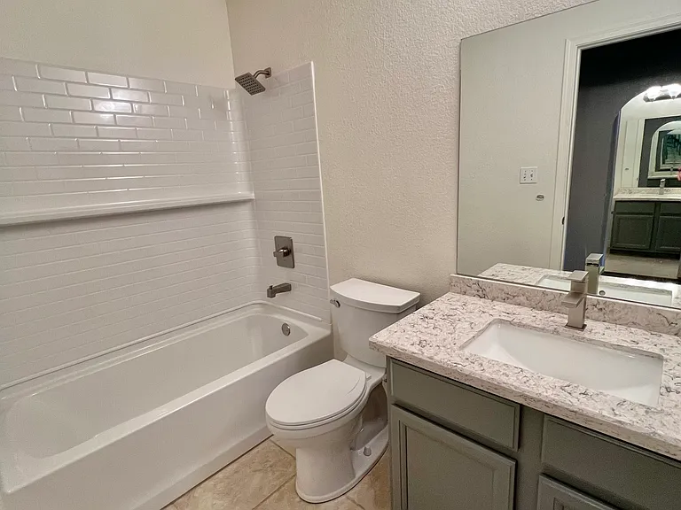 Secondary bedroom bathroom has quartz countertop. New shower/tub combo, toilet and bathroom faucet in July 2026.