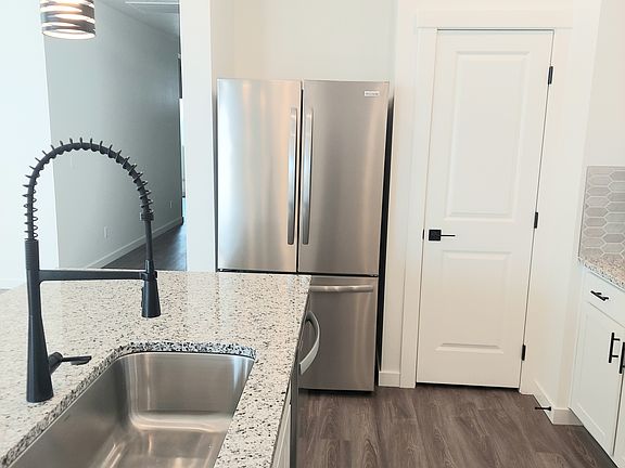 Kitchen with new refrigerator and pantry door