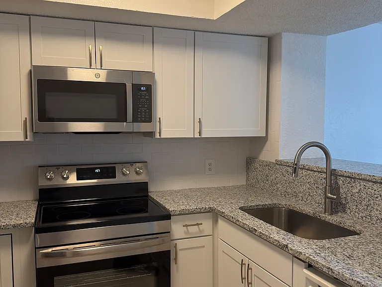 Kitchen with new cabinetry, granite countertops, extra large sink.