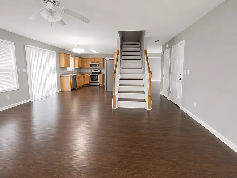 Open-concept kitchen overlooking the main living area, complete with stainless steel appliances and abundant natural light.