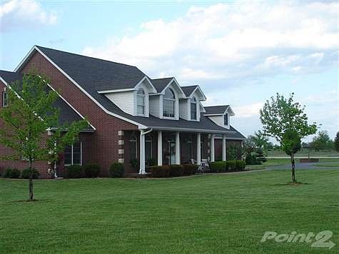 Dramatic Country Estate on 3 Acres only 5 minutes so. of Spfd!!!! Thick pillars and covered front porch are so pretty along with the lush landscape and circle drive!  Notice the new roof!  Wow!  This is a DREAM HOME!!!