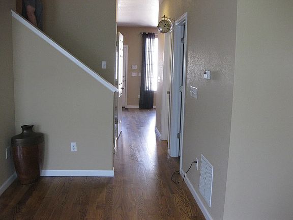 Hallway from entryway leading back to kitchen