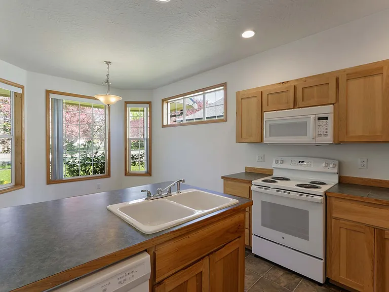 Kitchen with eating area. Countertops upgraded to granite since photo was taken.