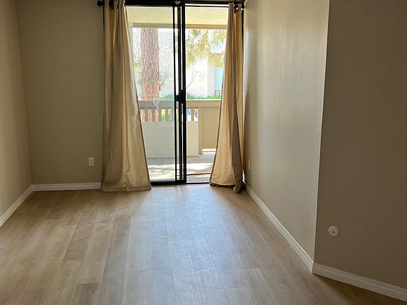 Spacious master bedroom with ample space for an office area or child's bed.