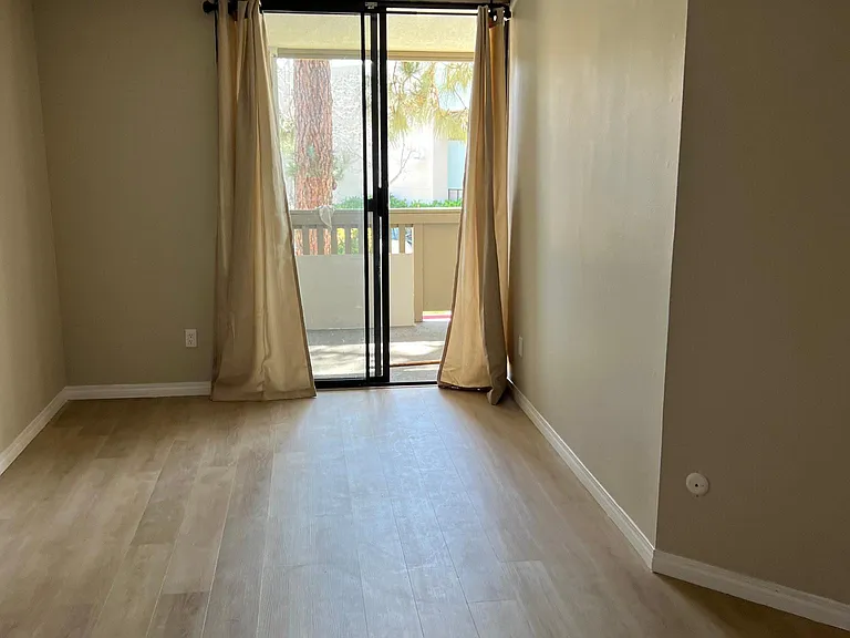 Spacious master bedroom with ample space for an office area or child's bed.