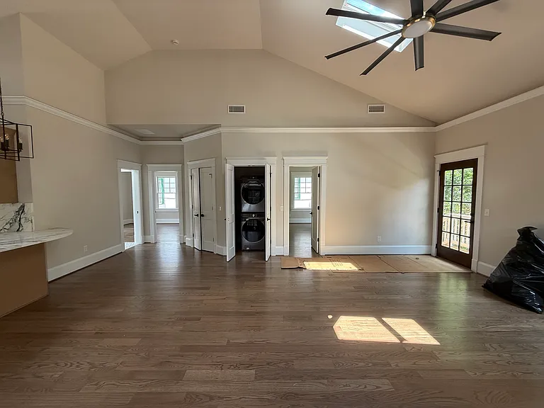 Main room with kitchen to the left and bedrooms straight ahead; full sized WD in middle