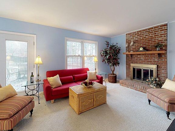 Window-filled family room with cozy fireplace