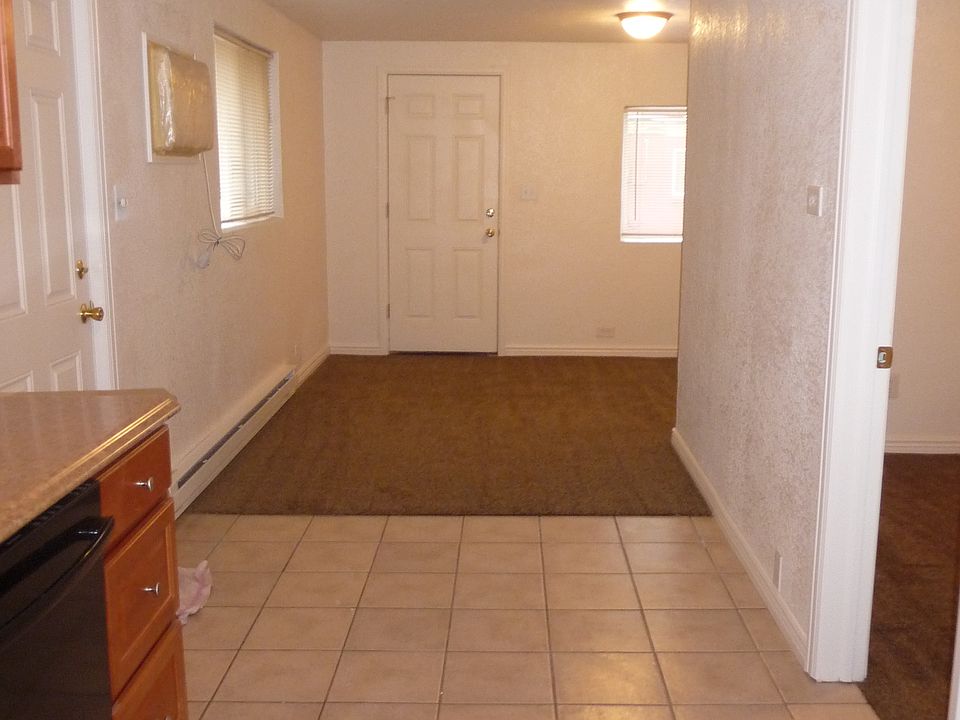 Looking from the kitchen, the bedroom door is on the right