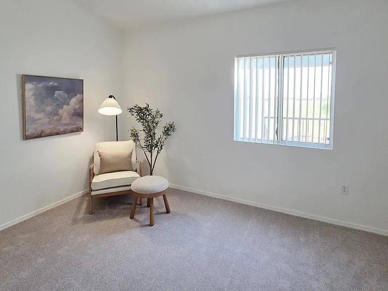Unwind in a bright, oversized bedroom featuring plush carpeting, a generous closet, and plenty of room for a king-sized bed and additional furniture.