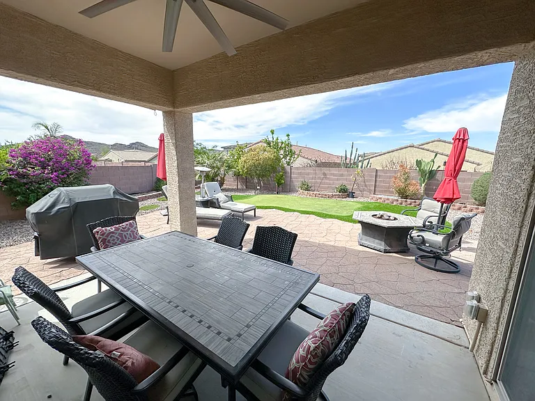 Spacious backyard w/patio, tons of privacy, and putting green.