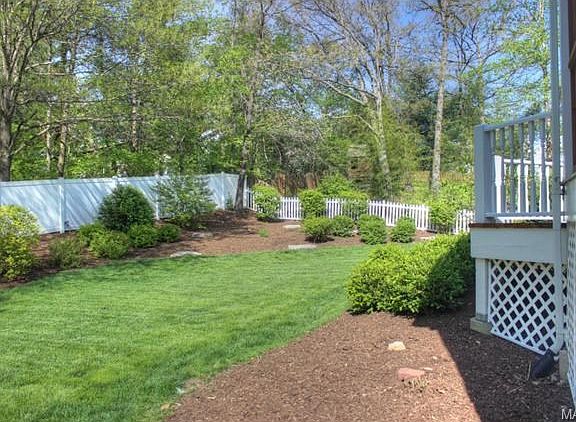 landscaped back yard with newer fence