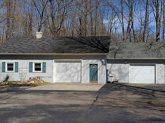 Bonus Guest House structure has 2 more garage stalls. Finished heated stall has workbench and sink.