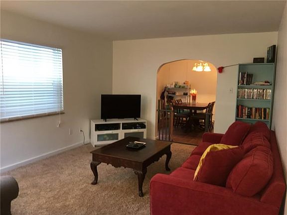 The 16x12 living room has newer wall to wall carpet and the large windows allow plenty of daylight to brighten the room.