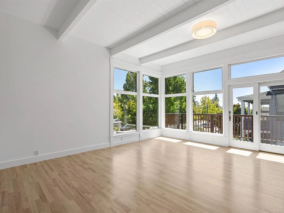 Floor to ceiling windows let in abundant natural morning light. High beamed ceilings. Refinished maple wood floors.