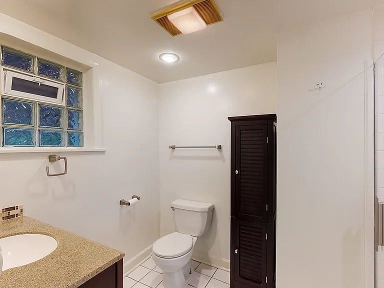 Bathroom with storage cabinet and shower