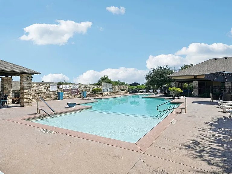 Unwind at the sparkling pool surrounded by lounge seating at Arroyo Seco Villas.