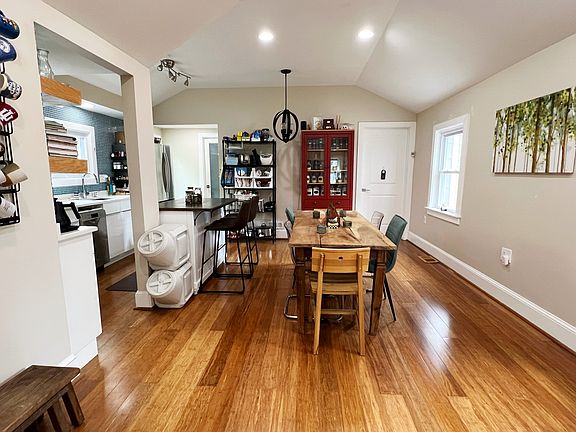 Open concept kitchen and dining space with a vaulted ceiling; can be configured for large dinner parties (as seen) or as a secondary living/office space depending on the priorities of your lifestyle