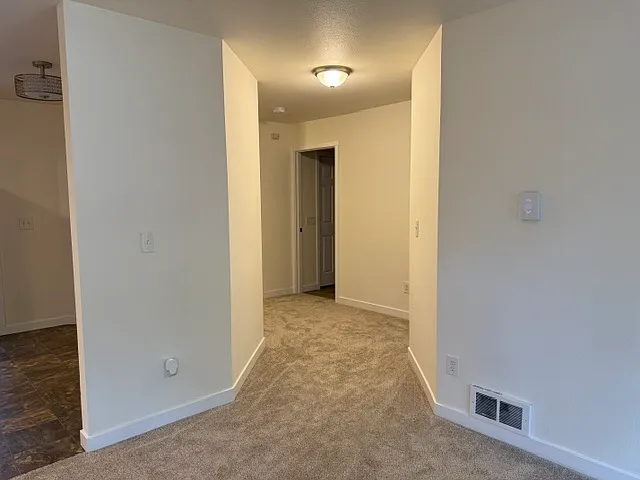 Hallway from living room, looking at bathroom