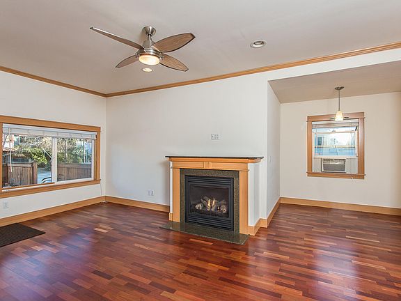Living room with gas fireplace and eating nook.