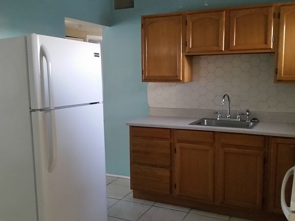 Wood kitchen cabinets with tile floors
