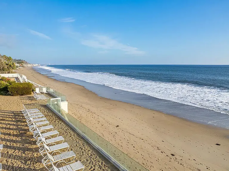 Stroll to the beach with direct access, where sun-kissed sands meet the gentle waves.