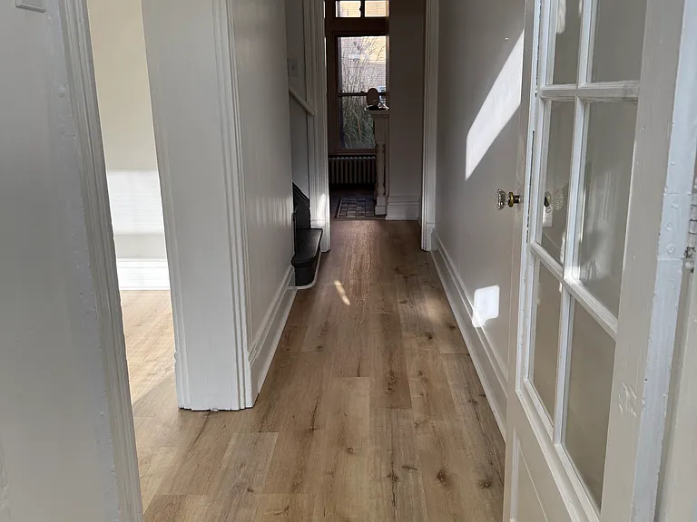 1st Floor Main Hallway which guides you to the living room on the left, then the stairs to the 2nd floor and finally, to the Dining Room, Kitchen & Garden