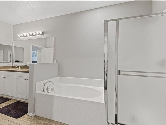 A soak-in tub and a step-in shower round-out the Master bath''s charm