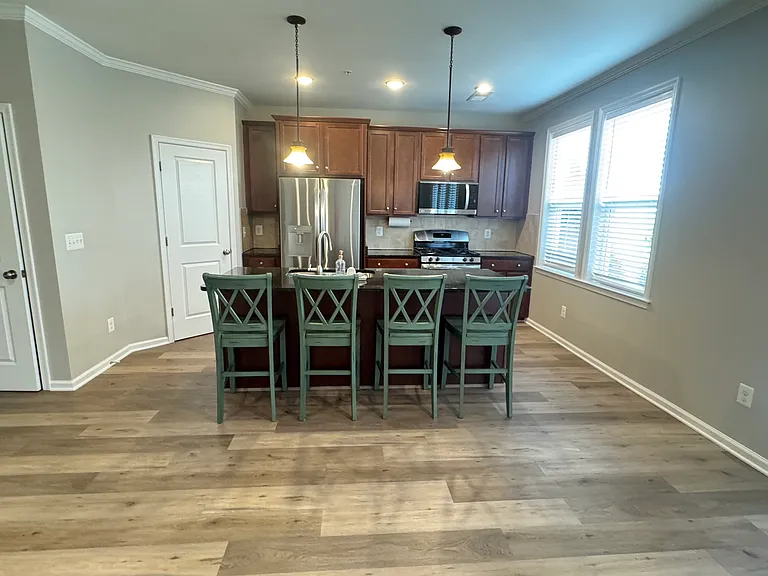 Second floor with kitchen, living area and half bath