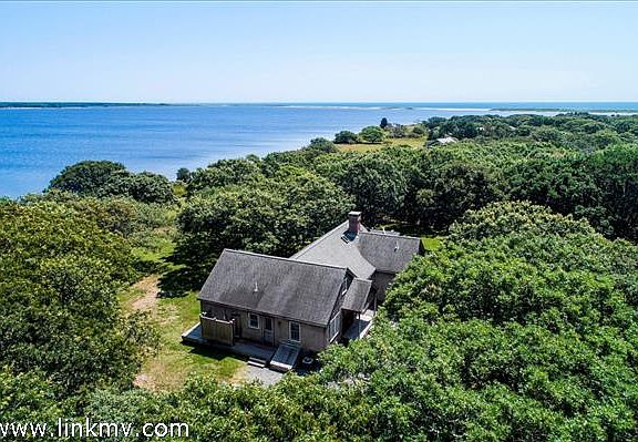The house looks out over miles of open blue water, with views of Tisbury Great Pond and the Atlantic.
