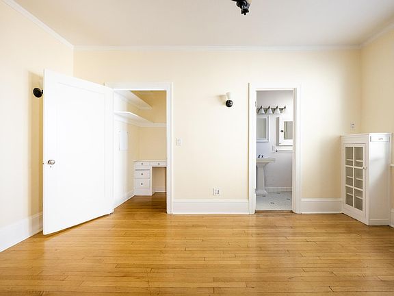 studio with walk-in closet with built in desk.