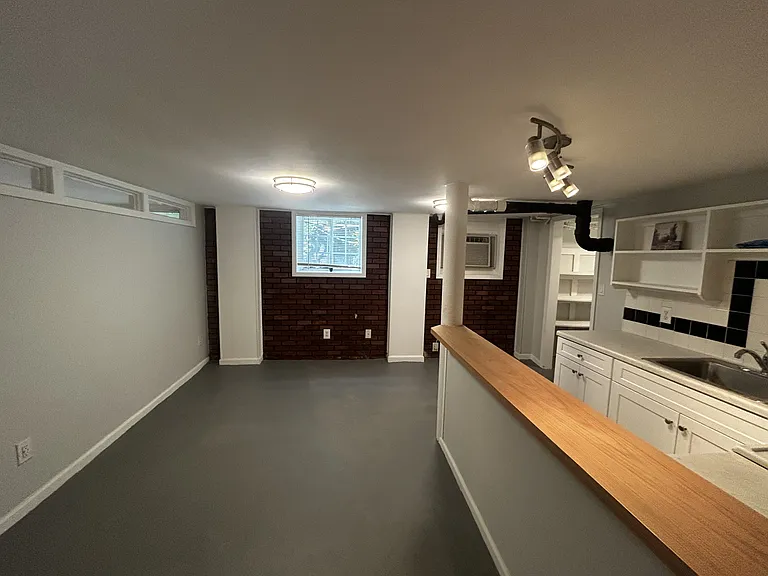 Living area and kitchen with barstool