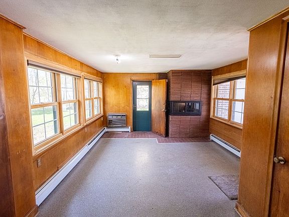 The entry/family room is filled with light. The door leads to the fenced backyard.