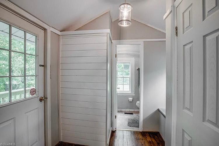 Hall/dressing area leads to bathroom. Door leads to a small private deck.