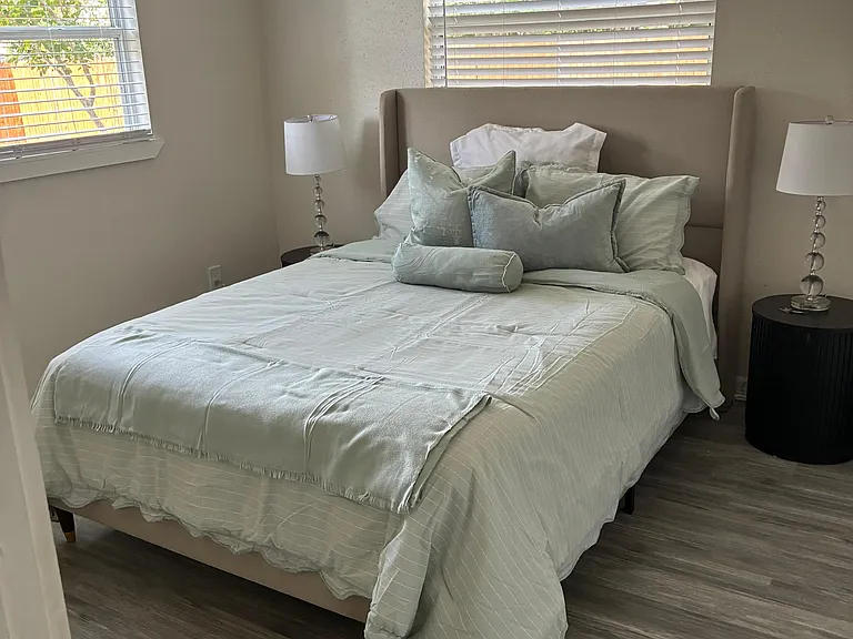 Bright bedroom with crisp bedding and plenty of natural light