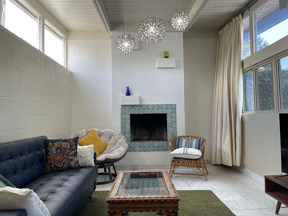 Living room with high ceiling and lots of light. Functioning fireplace. View of the courtyard.