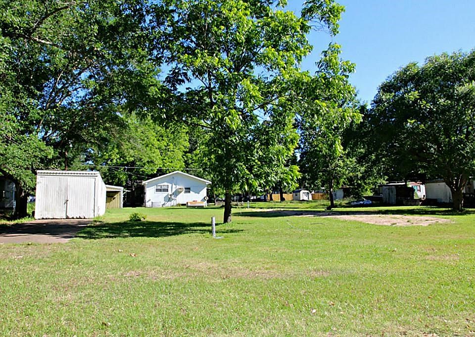 Mobile home ready lot with septic, electric pole with breaker box, water, boat storage shed with concrete pad and pad for mobile home.