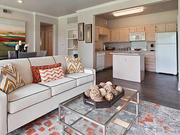 Spacious Living Room and Kitchen with Quartz Countertops, White Appliances, and Island