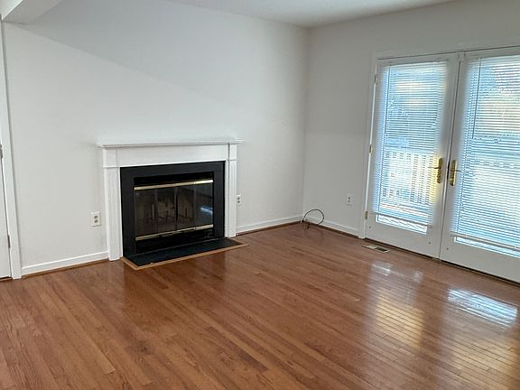 Den with fireplace and French doors to the deck this is fully open to the kitchen and bar.
