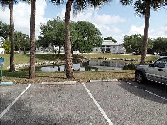 One of two ponds on property. Mature oak and palm trees in community.