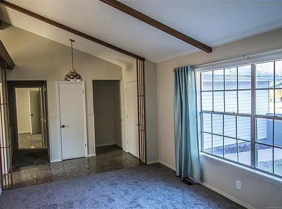 Living Room- The vaulted ceiling accented by wood beams creates a marvelous space for entertaining family and friends.