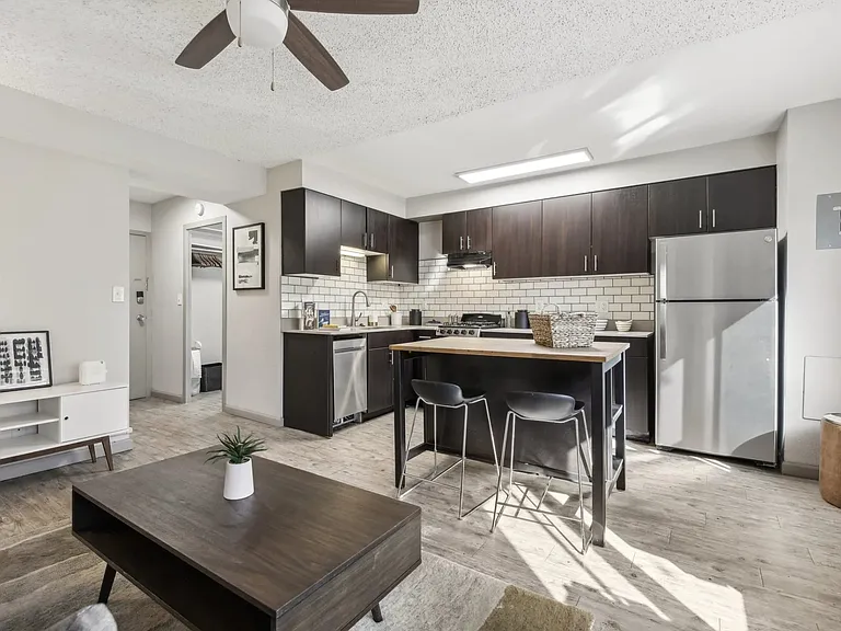 Stylish kitchen open to the living room at Archer Tower in Denver, CO