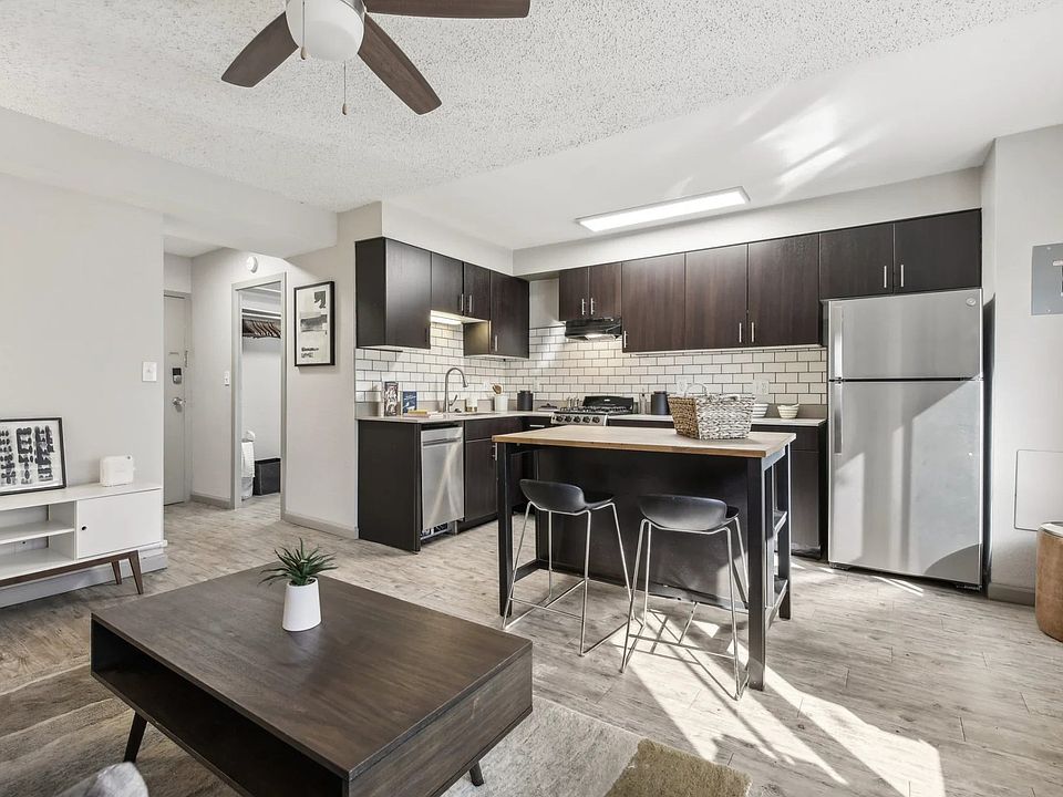 The kitchen area is updated for a modern look with dark wood cabinets and updated appliances
