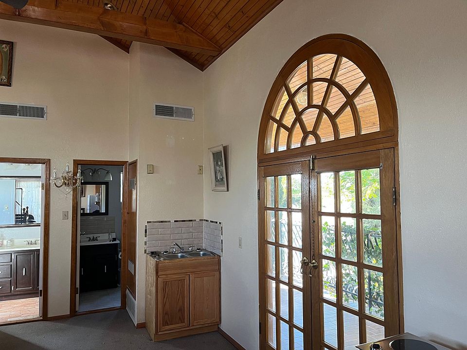 Three French Doors to outdoor patio. Kitchenette with sink.