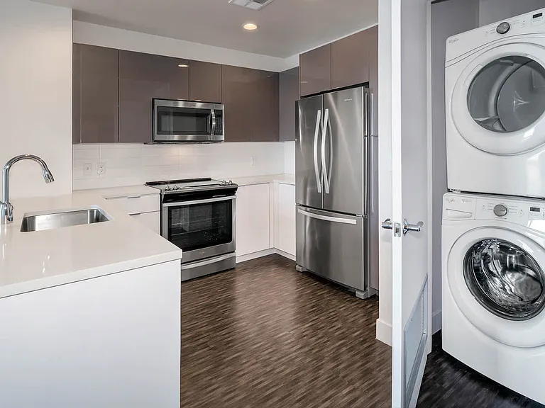 Kitchen with Stainless Steel Appliances and In-home Washer and Dryer