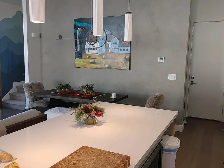 Large kitchen island and dining table with specialty painted accent wall