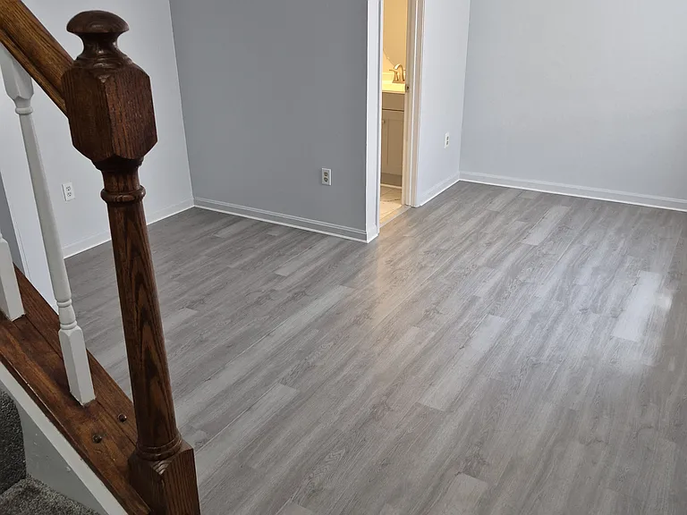 Family Room with half bath. Two windows for extra sunlight. New LVT flooring.