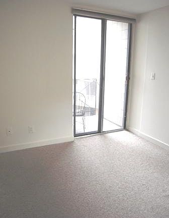 Small bedroom with balcony.