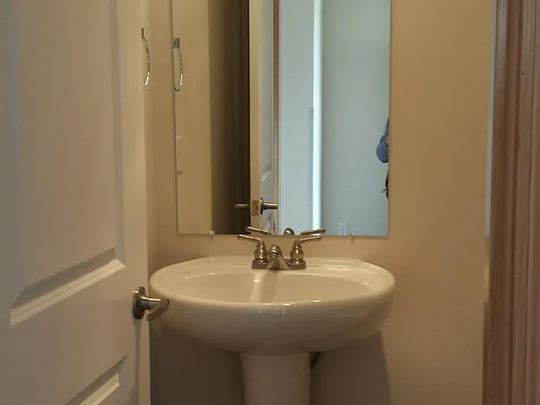 Downstairs half bath conveniently located next to entry and garage access doors.