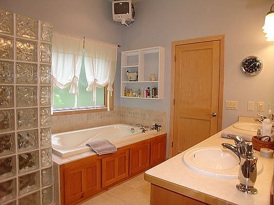 Spacious master bath with glass block and huge walk in closet